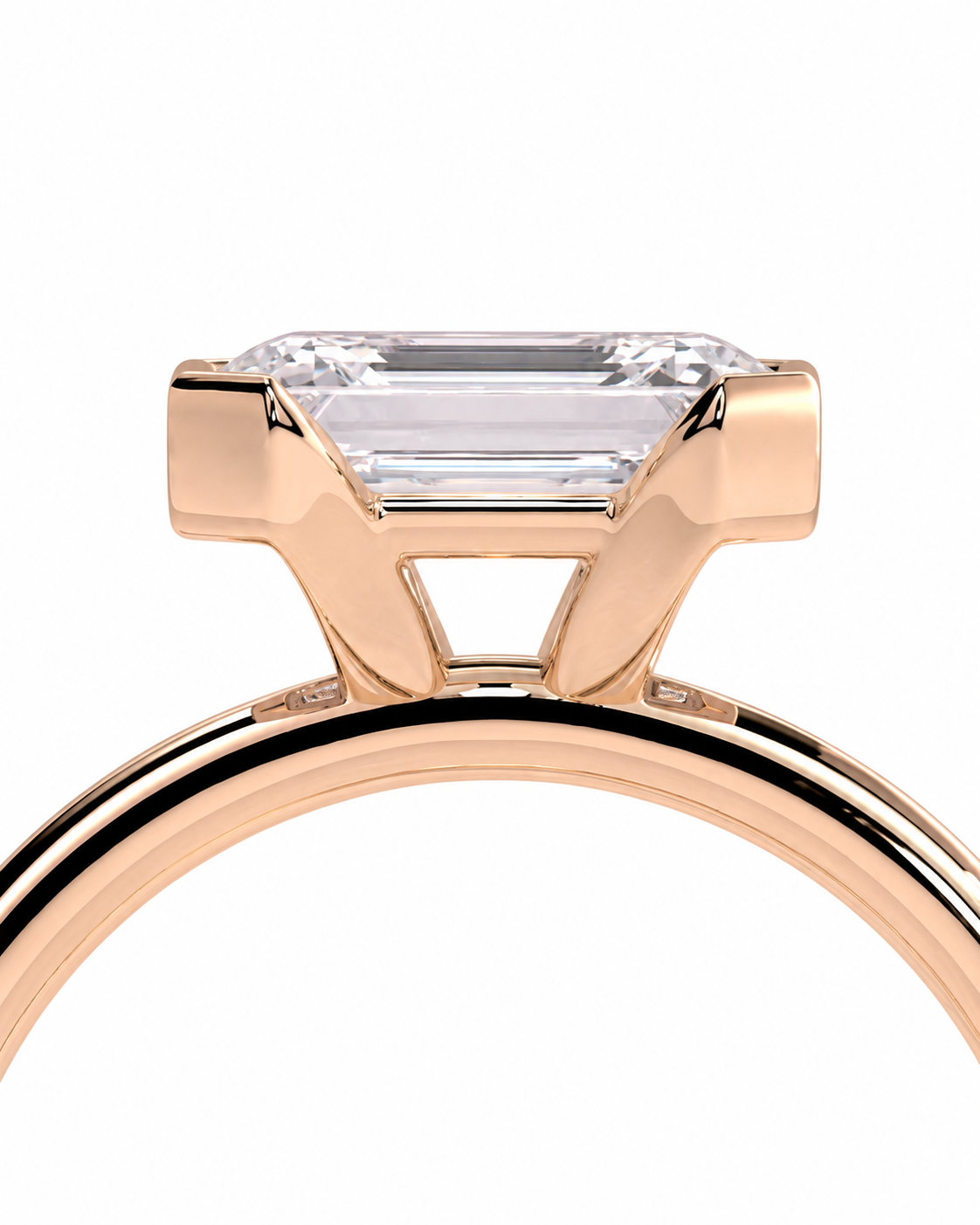 color_10K_RG, color_14K_RG &&A close-up of a rose gold ring featuring an emerald-cut clear gemstone in a prong setting, shown against a solid white background.