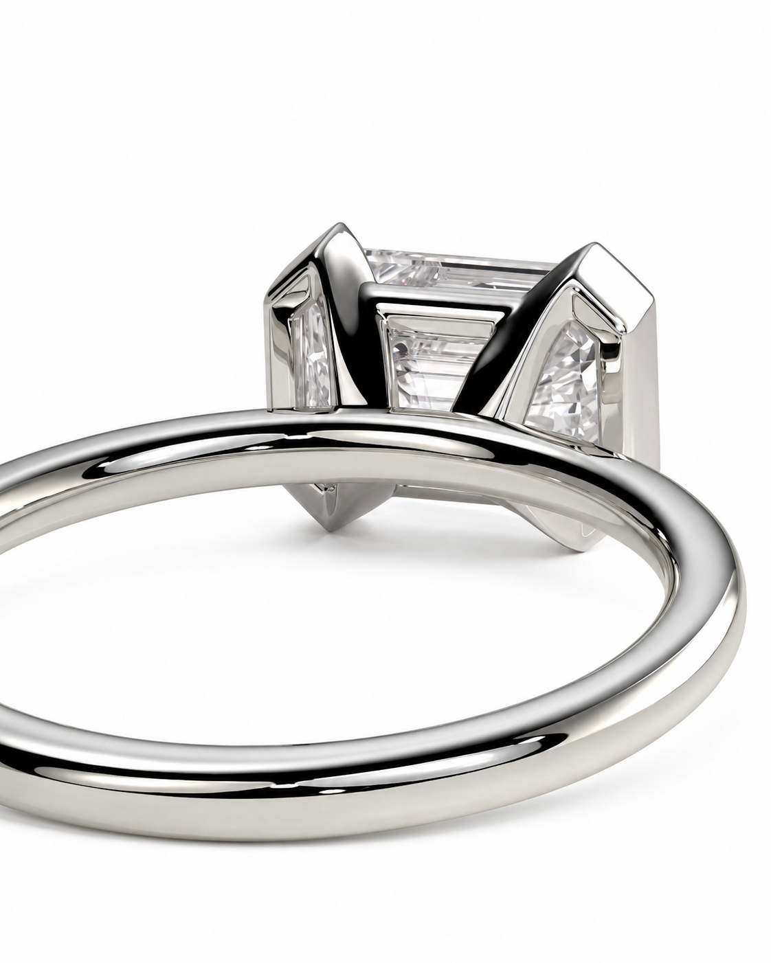 color_925_SIL,color_935_ARG,color_10K_WG, color_14K_WG &&A close-up studio shot of a silver-toned ring featuring a baguette-cut clear center stone and smaller side stones in a geometric setting, shown against a plain white background.