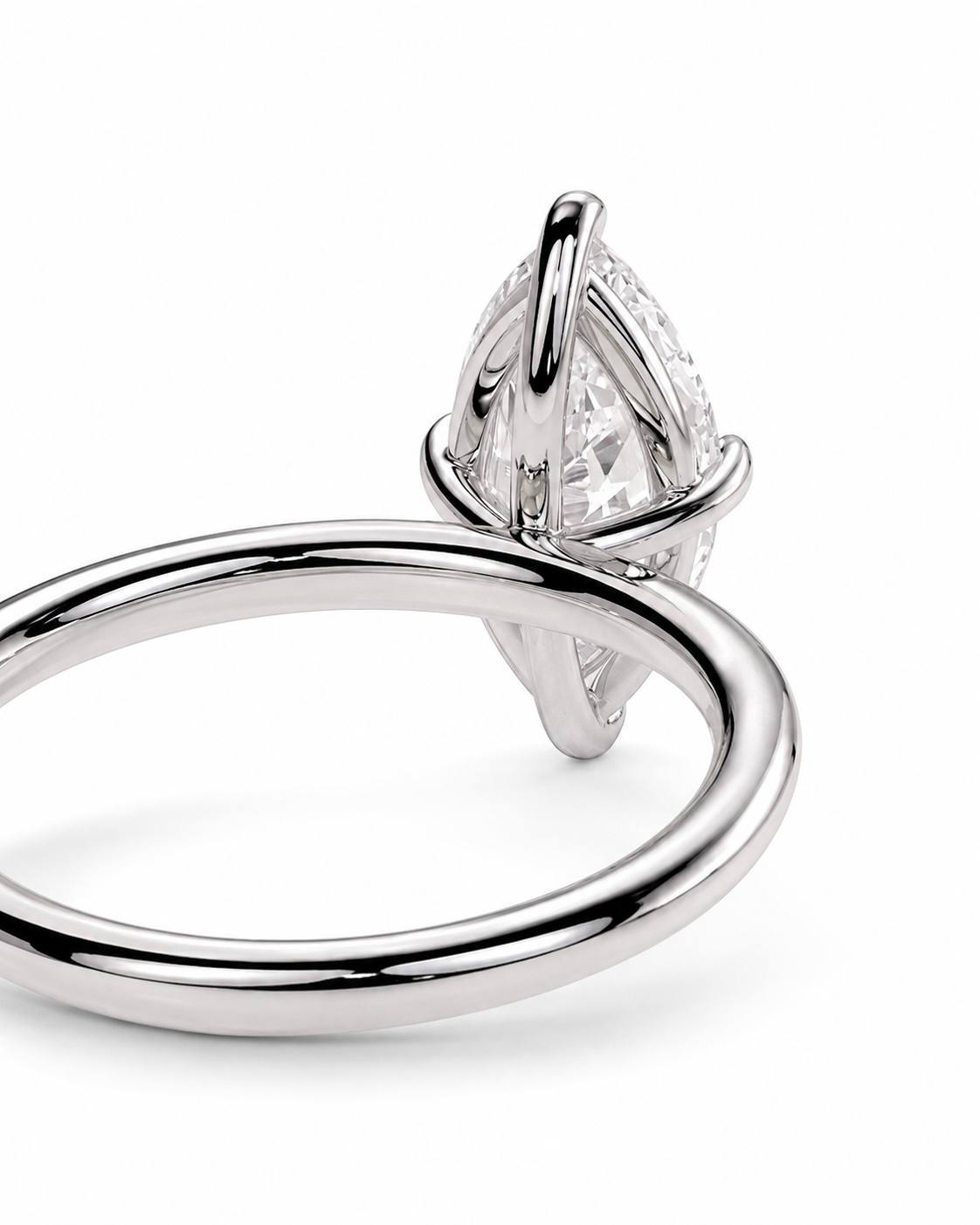 color_925_SIL,color_935_ARG,color_10K_WG, color_14K_WG &&A close-up studio shot of a silver-toned ring featuring a marquise-cut clear gemstone in a prong setting, shown against a plain white background.