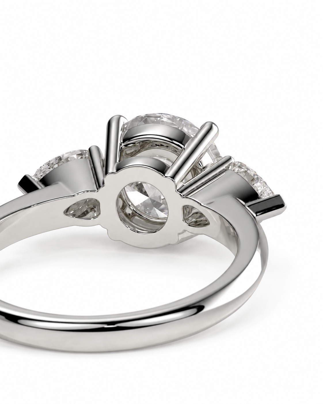 color_925_SIL,color_935_ARG,color_10K_WG, color_14K_WG &&A close-up studio shot of a silver-toned ring with a three-stone setting, featuring clear gemstones in a prong design on a white background.