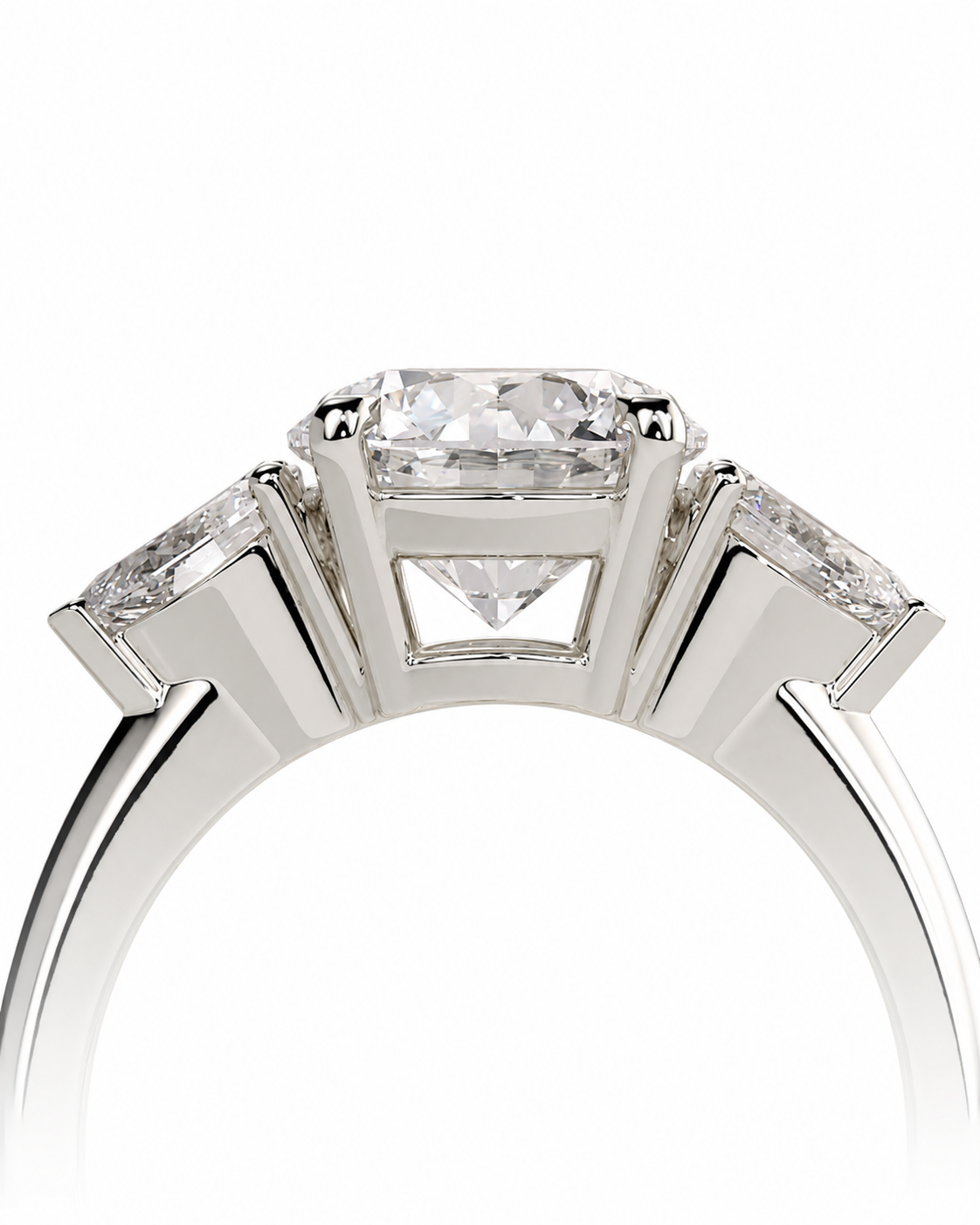 color_925_SIL,color_935_ARG,color_10K_WG, color_14K_WG &&A close-up studio shot of a silver-toned diamond ring featuring a central cushion-cut diamond surrounded by two baguette-cut diamonds on the shoulders, set against a plain white background.
