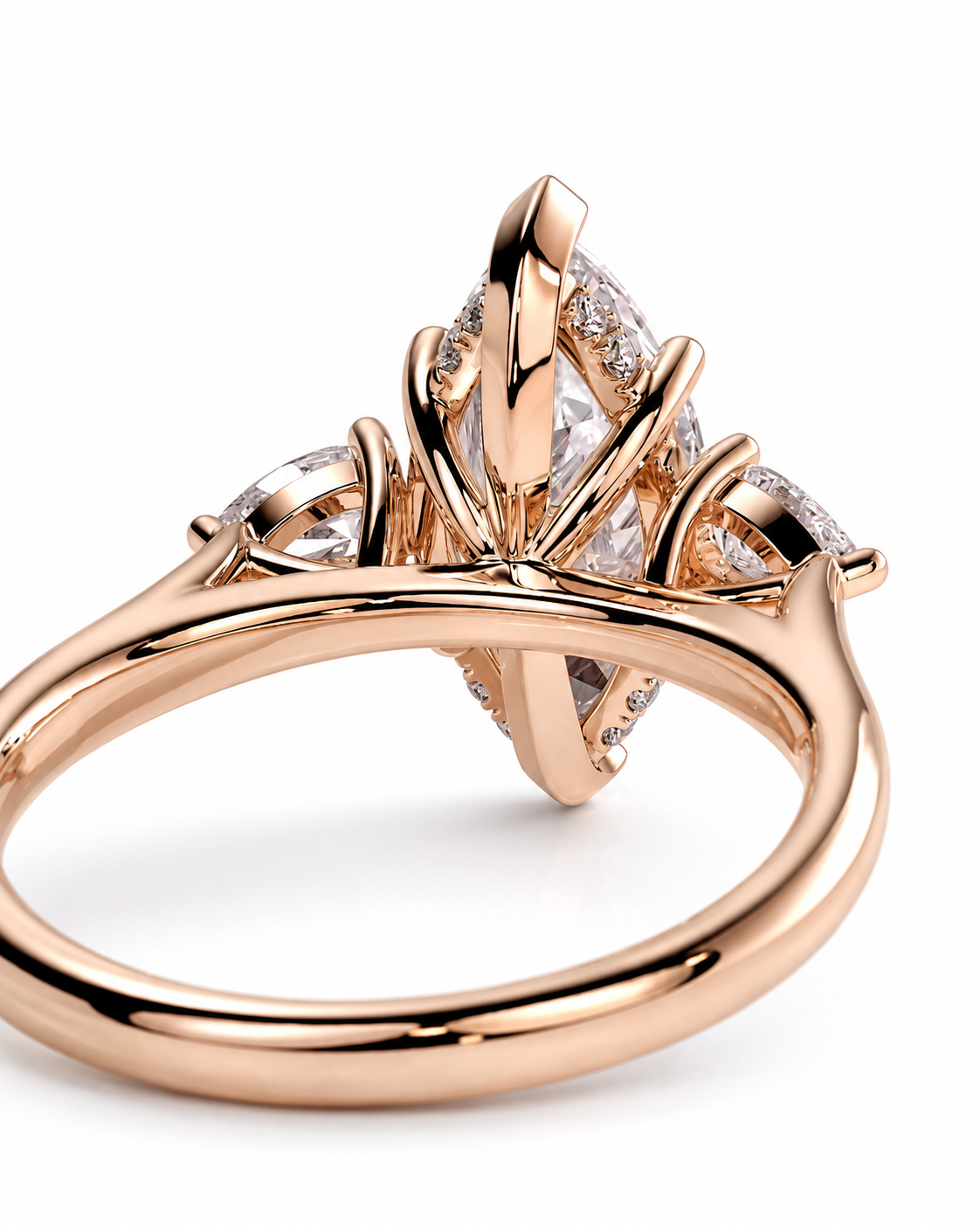 color_10K_RG, color_14K_RG &&Rose gold ring with a marquise-cut center stone and smaller round stones, shown in a close-up studio shot on a white background.