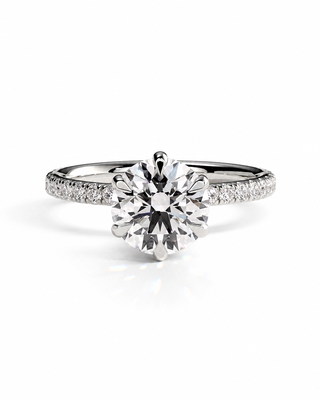 color_925_SIL,color_935_ARG,color_10K_WG, color_14K_WG &&A radiant cluster diamond engagement ring in a silver-colored metal band, featuring a large round-cut center diamond and smaller diamonds along the shoulders, set against a clean white background.