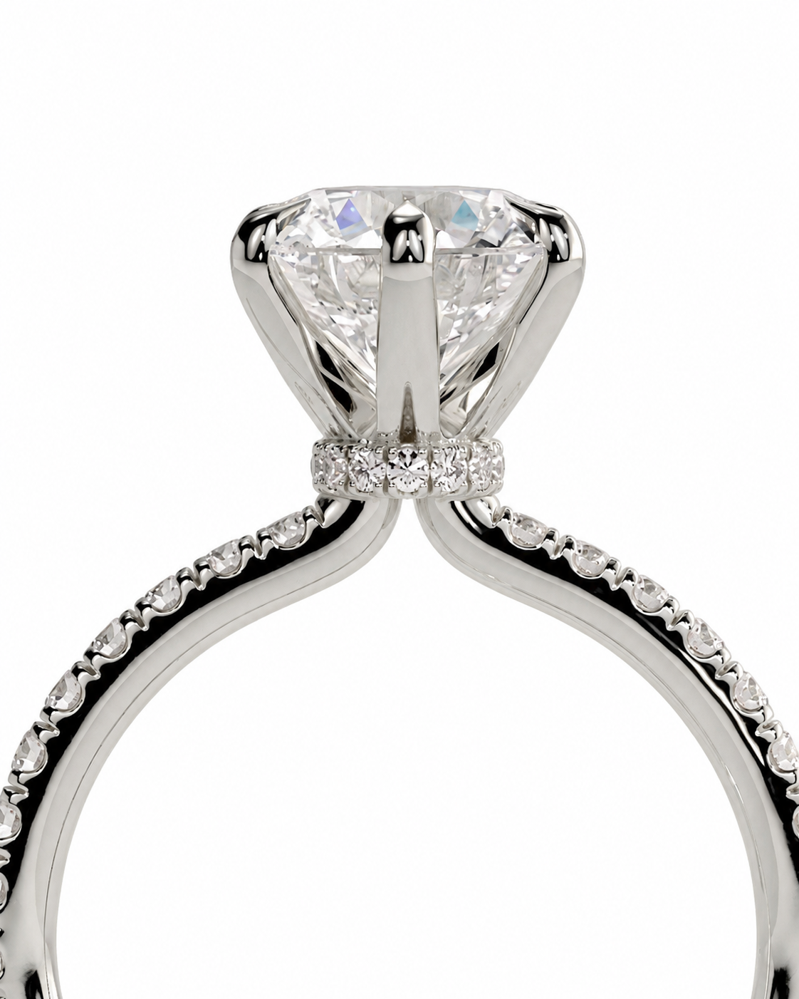 color_925_SIL,color_935_ARG,color_10K_WG, color_14K_WG &&A close-up studio shot of a silver-toned solitaire engagement ring with a large round brilliant-cut center stone and a halo of small accent diamonds, set against a plain white background.