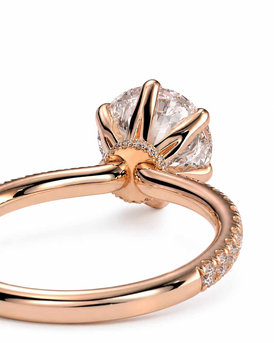 color_10K_RG, color_14K_RG &&Rose gold engagement ring with a large round clear center stone and small accent stones along the band, shown on a white background.