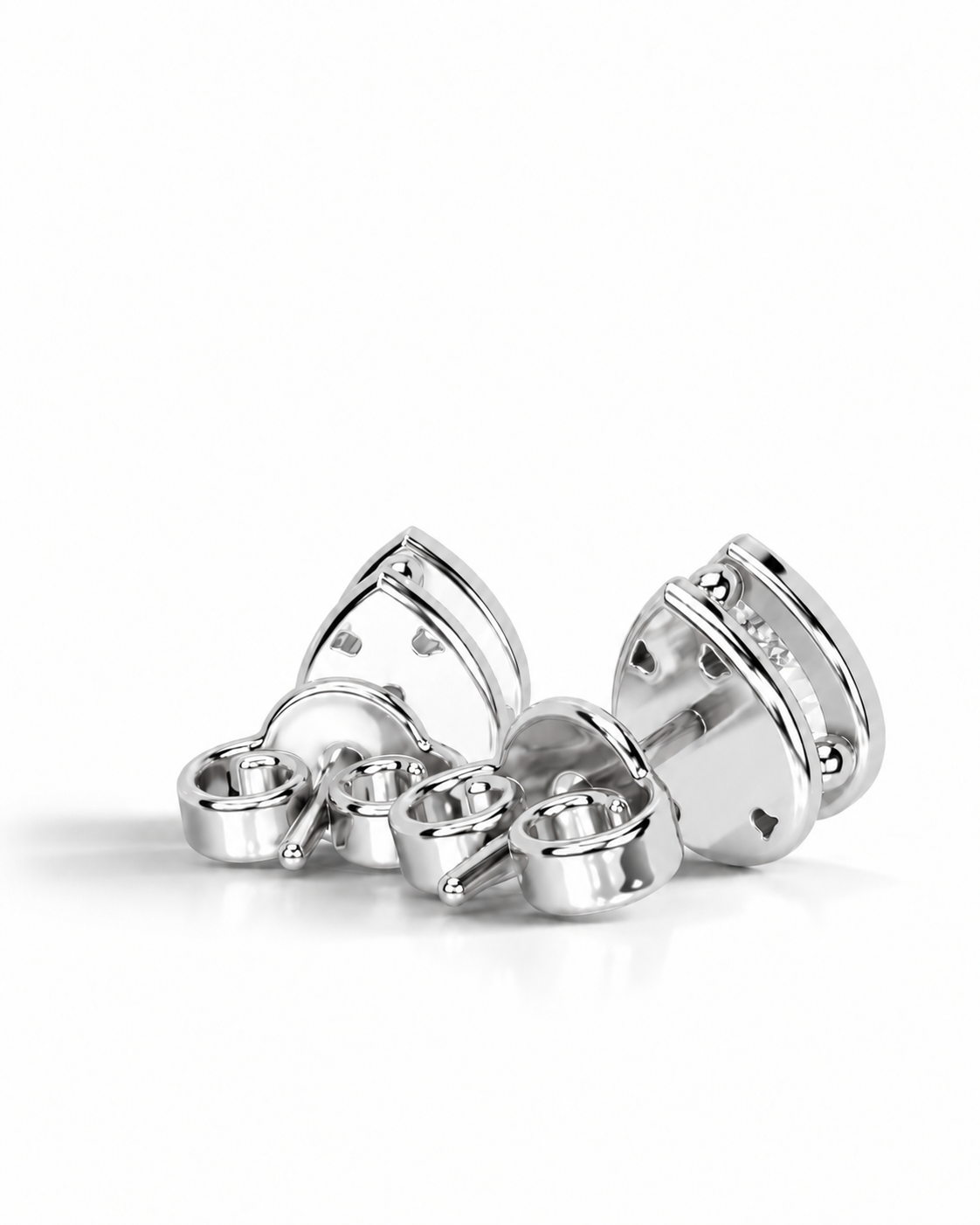 color_925_SIL,color_935_ARG,color_10K_WG, color_14K_WG &&A pair of silver-toned metal stud earrings with a polished, geometric triangular design and small clear stones, displayed on a clean white background.