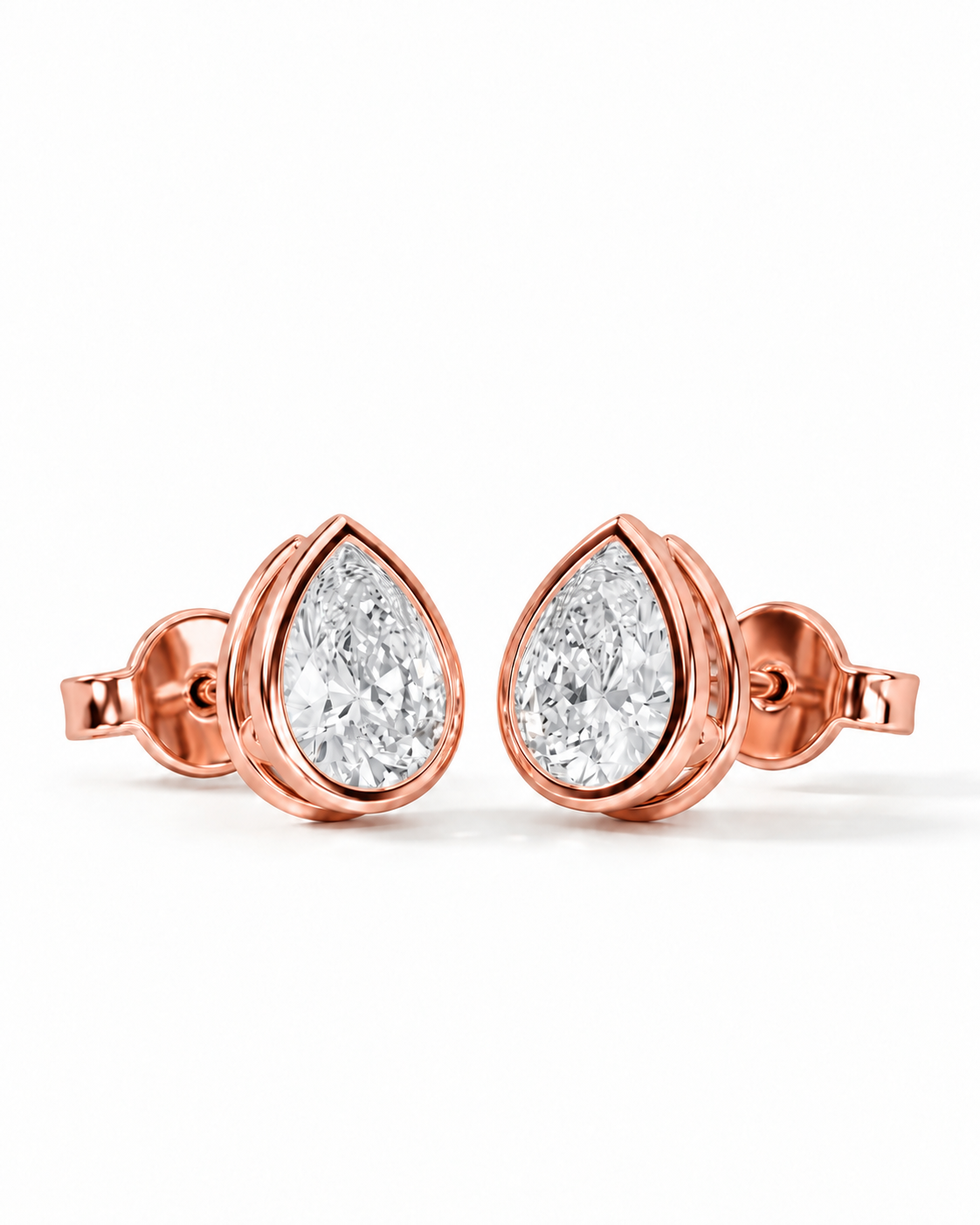 color_10K_RG, color_14K_RG &&A pair of rose gold stud earrings featuring pear-cut clear gemstones in a bezel setting, displayed on a clean white background.