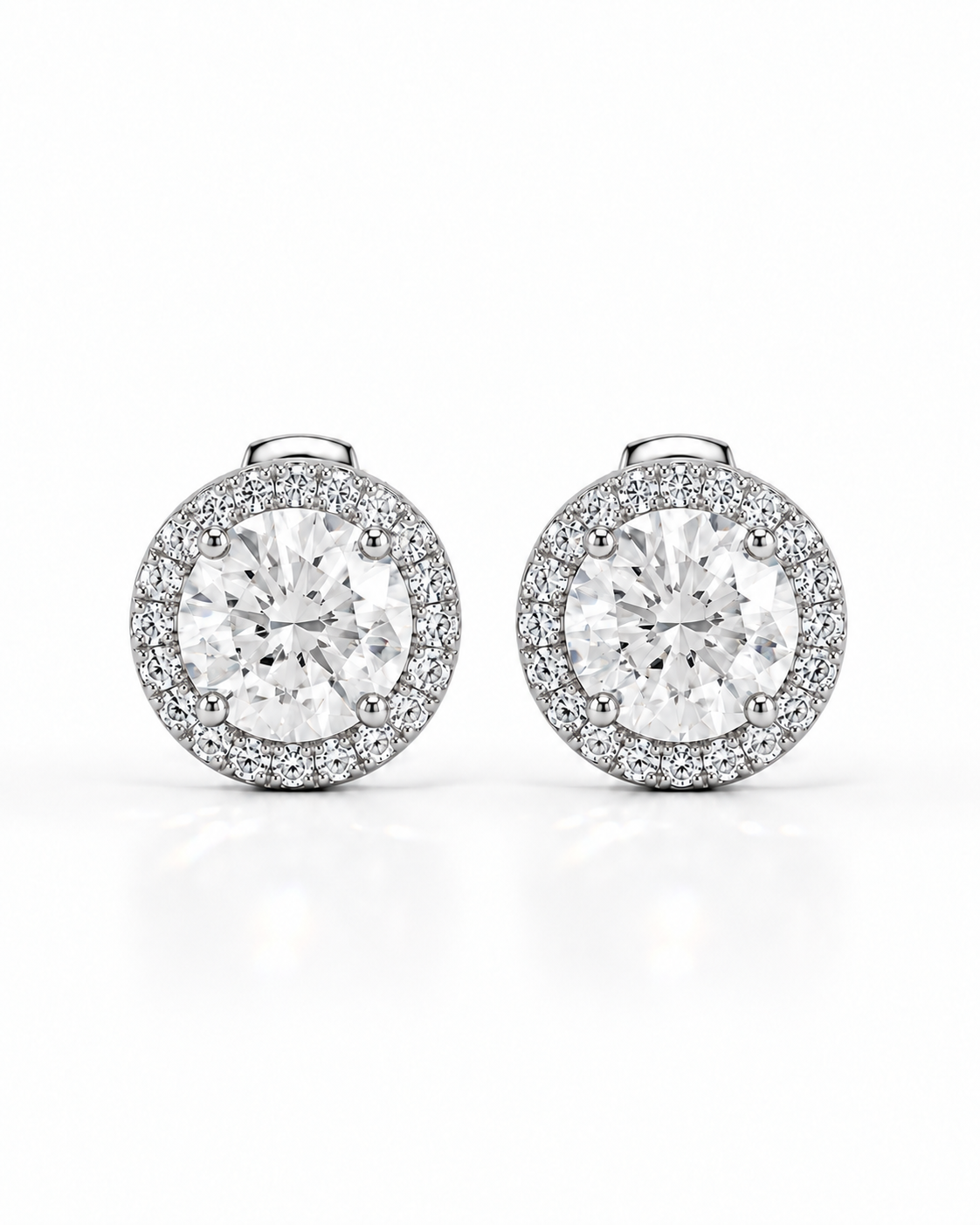 color_925_SIL,color_935_ARG,color_10K_WG, color_14K_WG &&A pair of round halo stud earrings featuring large clear center stones surrounded by a halo of smaller pave-set stones in a silver-toned setting, shown on a clean white background.