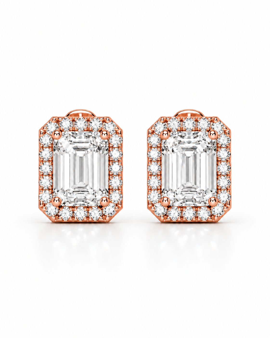 color_10K_RG, color_14K_RG &&A pair of rose gold stud earrings featuring a large emerald-cut clear center stone surrounded by a halo of smaller round stones, set against a clean white background.
