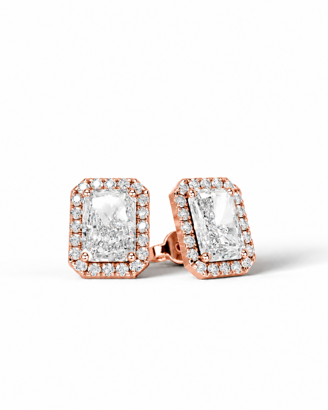 color_10K_RG, color_14K_RG &&A pair of rose gold stud earrings featuring large rectangular clear gemstones surrounded by smaller pave-set stones, shown on a clean white background.