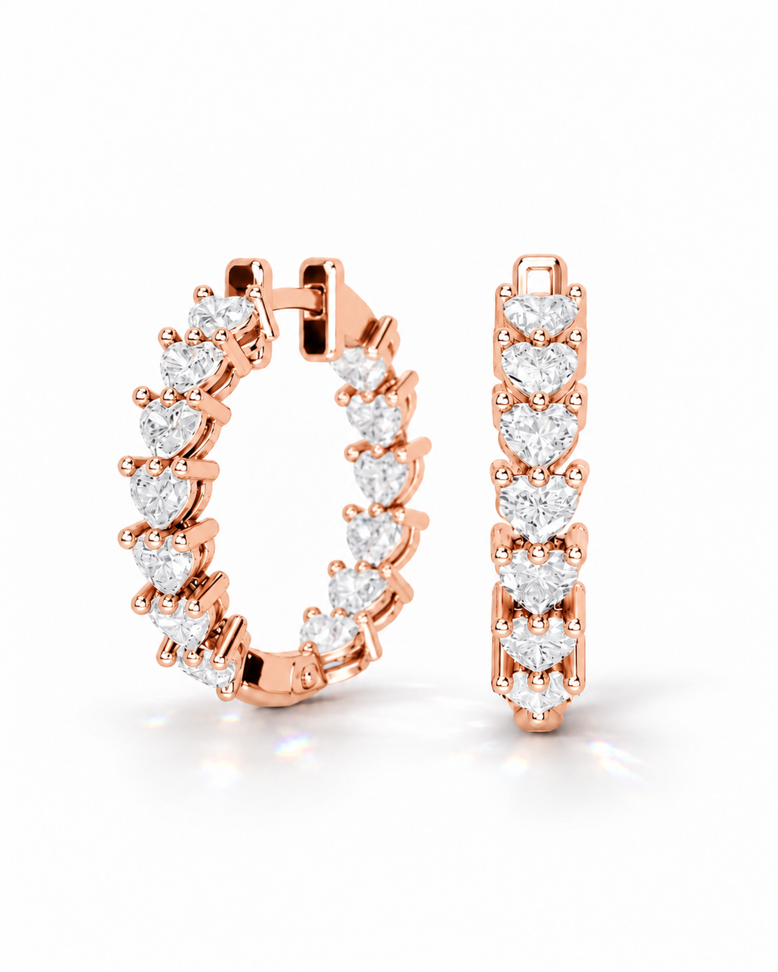 color_10K_RG, color_14K_RG &&Rose gold hoop earrings with a continuous row of heart-shaped clear gemstones, shown on a clean white background with one earring in profile and one front-facing.