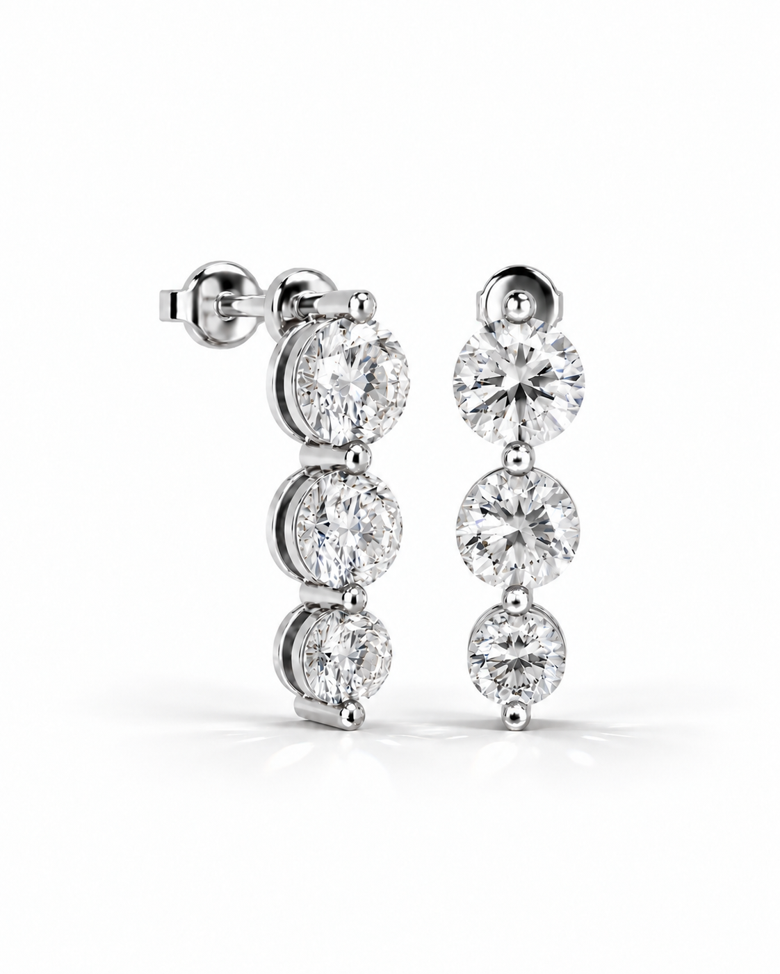 color_925_SIL,color_935_ARG,color_10K_WG, color_14K_WG &&A pair of silver-tone drop earrings with three round-cut clear gemstones in each earring, shown on a clean white background.