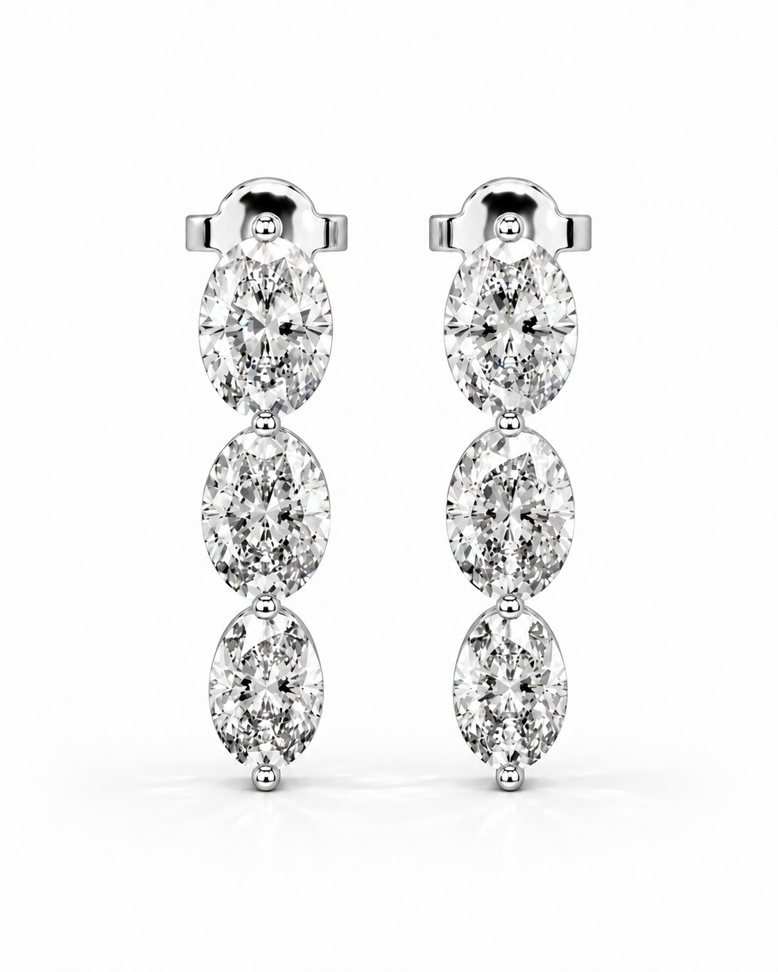 color_925_SIL,color_935_ARG,color_10K_WG, color_14K_WG &&A pair of silver-toned drop earrings featuring three marquise-cut clear gemstones in a vertical setting, shown against a plain white background.