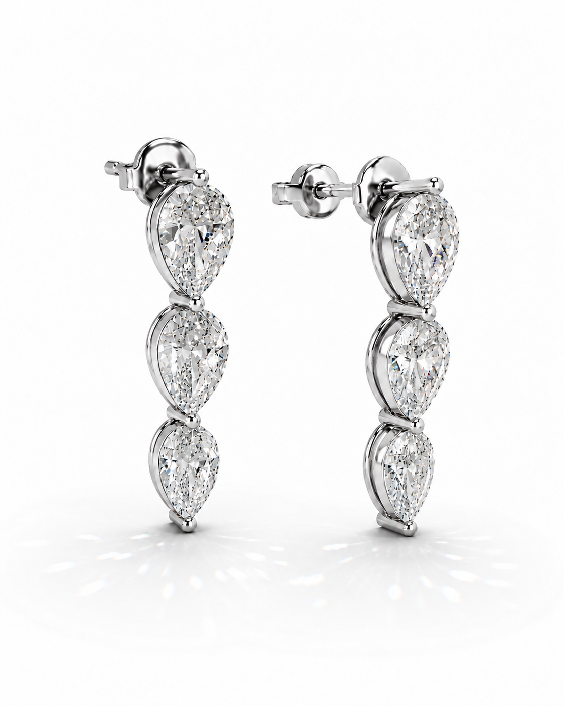 color_925_SIL,color_935_ARG,color_10K_WG, color_14K_WG &&A pair of silver-toned drop earrings featuring three pear-cut clear gemstones in a vertical arrangement, set in a sparkling pave-style metal, on a clean white background.