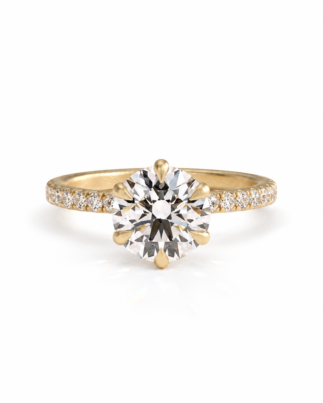 color_10K_YG, color_14K_YG &&A yellow gold solitaire engagement ring featuring a large round brilliant-cut center stone and a pavé-set band with small accent diamonds, shown on a clean white background.