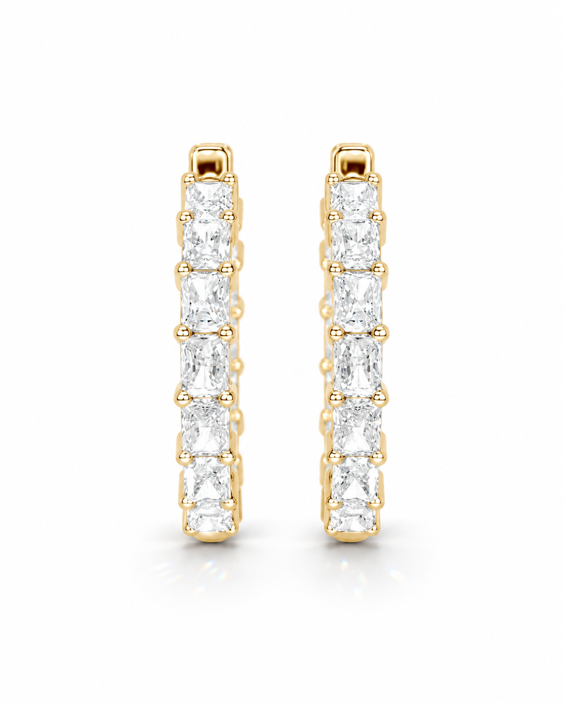 color_10K_YG, color_14K_YG &&A pair of gold huggie hoop earrings with a channel setting of baguette-cut clear gemstones, shown on a clean white background.