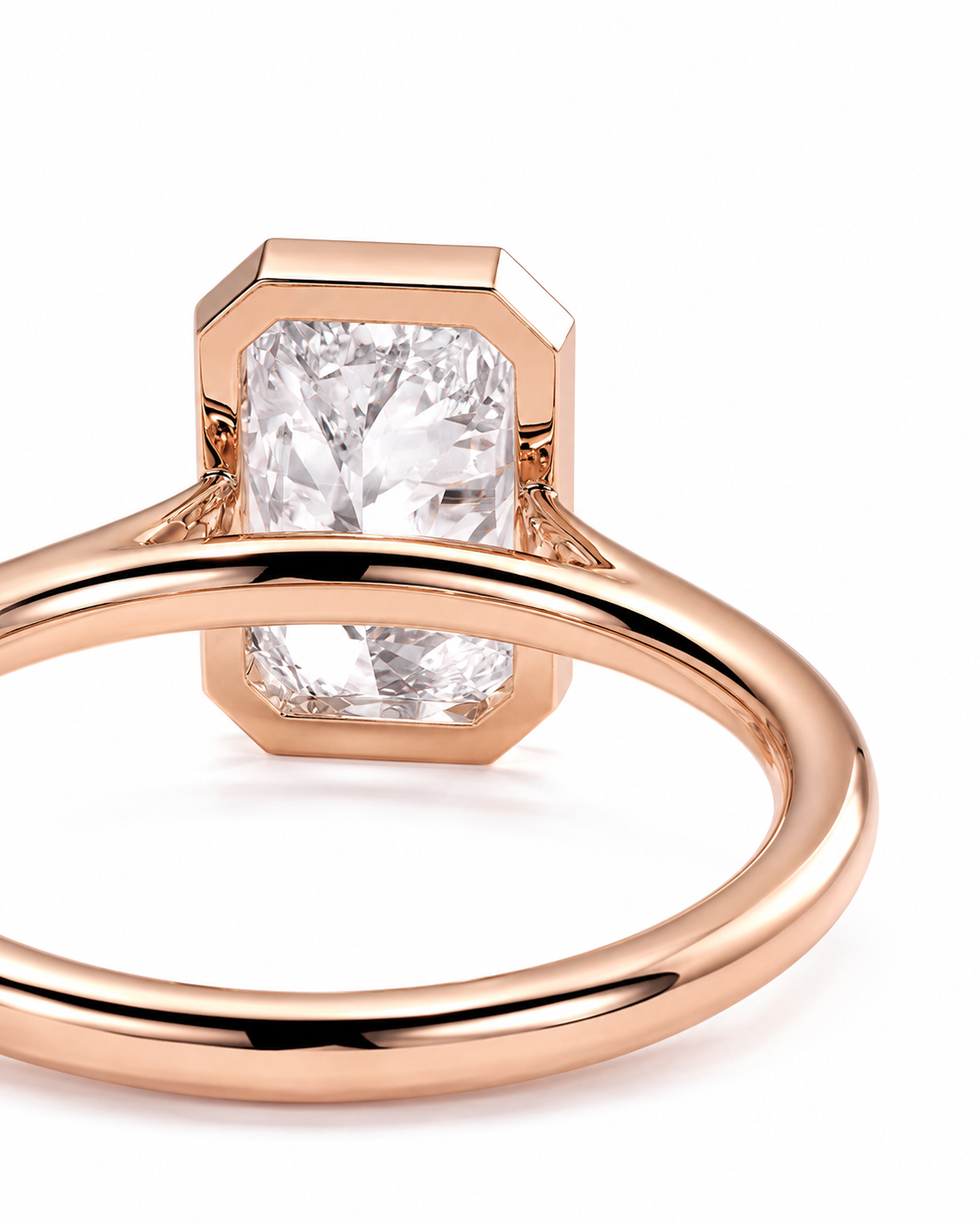 color_10K_RG, color_14K_RG &&A close-up studio shot of a rose gold ring with a large rectangular clear gemstone in a bezel setting, on a clean white background.