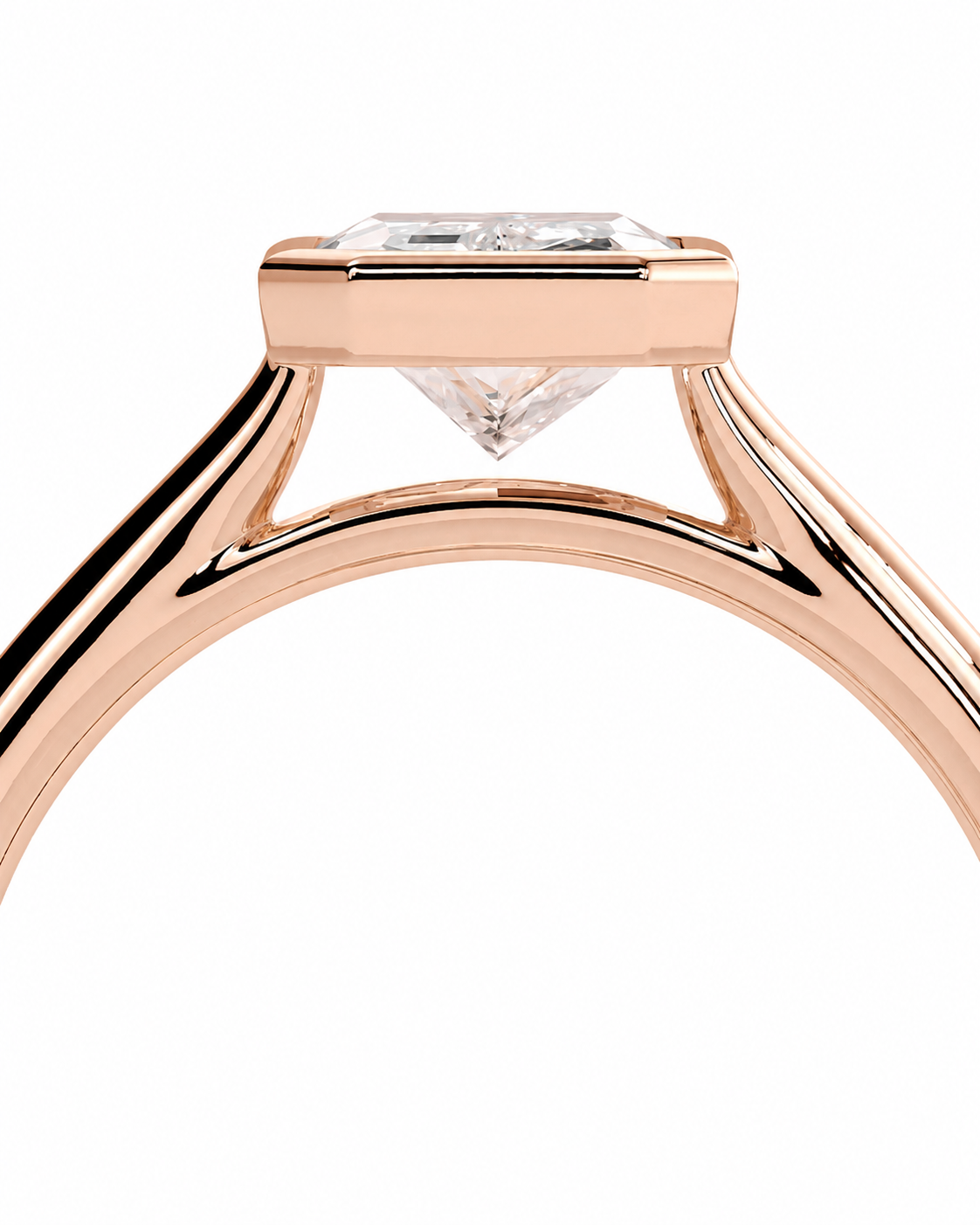 color_10K_RG, color_14K_RG &&Close-up of a rose gold ring setting with a clear rectangular gemstone on a white background.