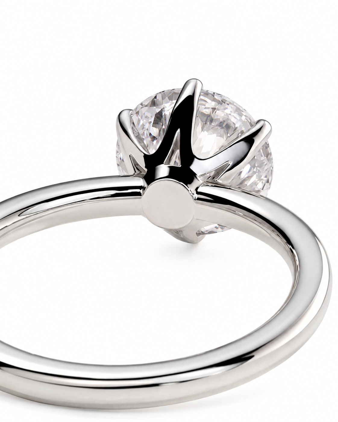color_925_SIL,color_935_ARG,color_10K_WG, color_14K_WG &&A close-up studio shot of a silver-toned solitaire ring with a round clear gemstone in a prong setting, shown against a plain white background.
