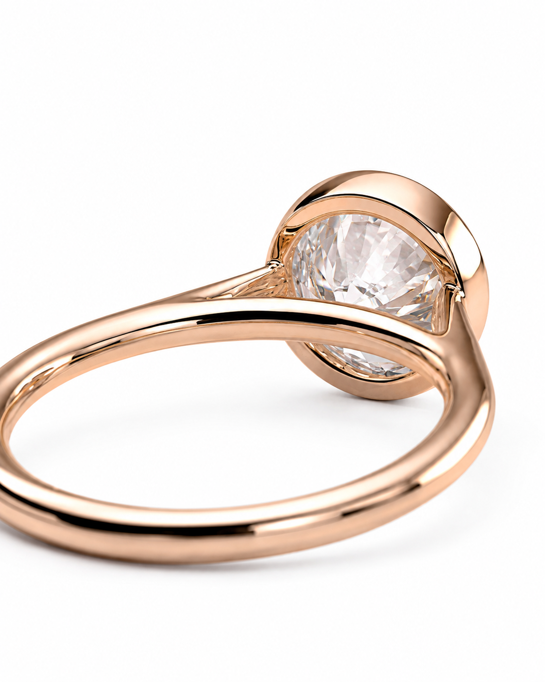 color_10K_RG, color_14K_RG &&A close-up shot of a rose gold ring with a large, clear round-cut gemstone in a prong setting, shown on a clean white background.