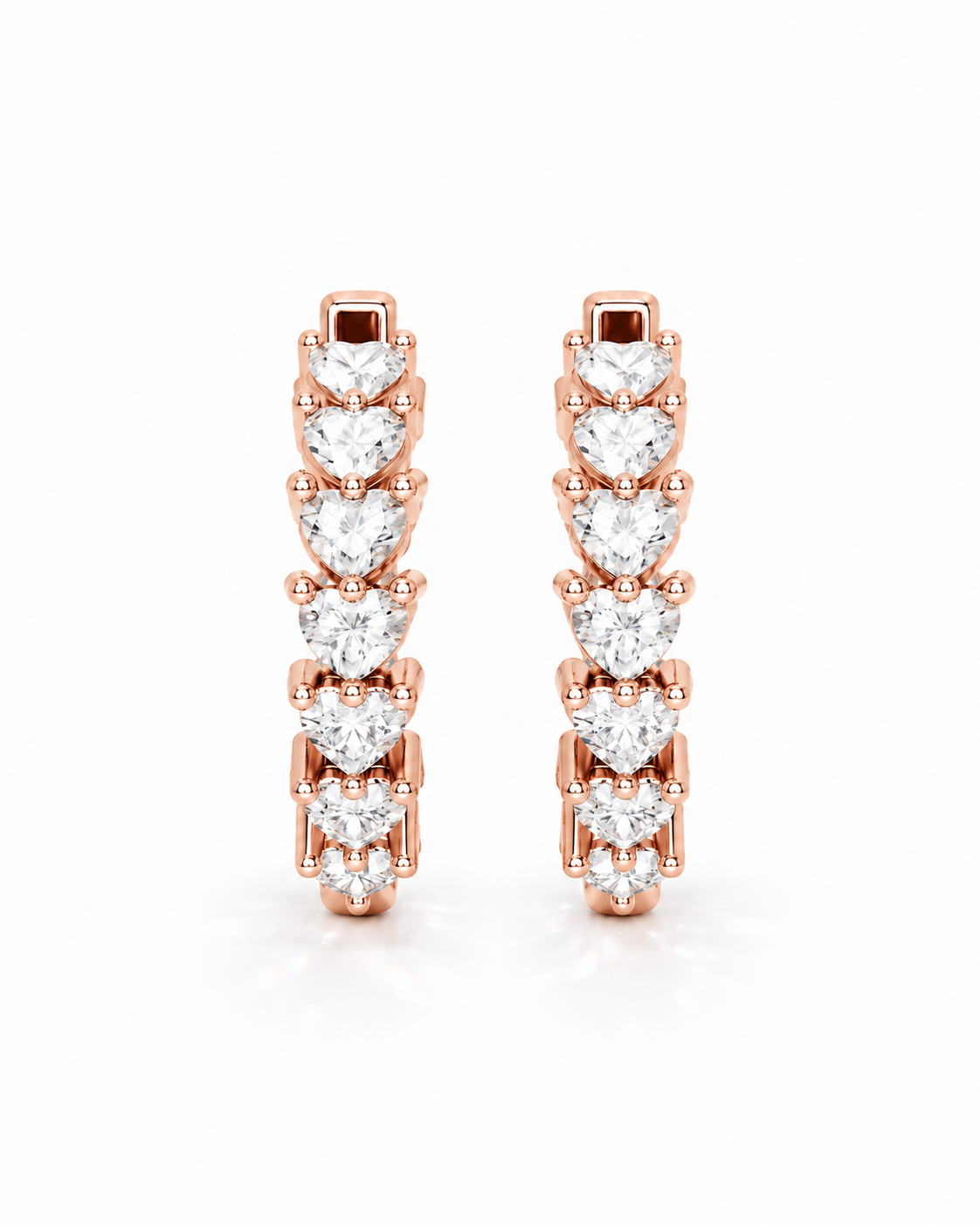 color_10K_RG, color_14K_RG &&A pair of rose gold huggie hoop earrings set with heart-shaped and round-cut clear gemstones, displayed on a clean white background.
