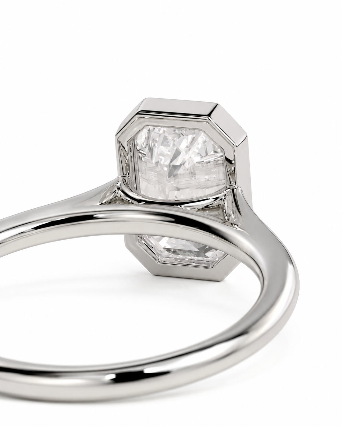 color_925_SIL,color_935_ARG,color_10K_WG, color_14K_WG &&A close-up studio shot of a silver-toned ring featuring a large, faceted clear gemstone in a geometric bezel setting, with a smaller matching stone below, on a plain white background.