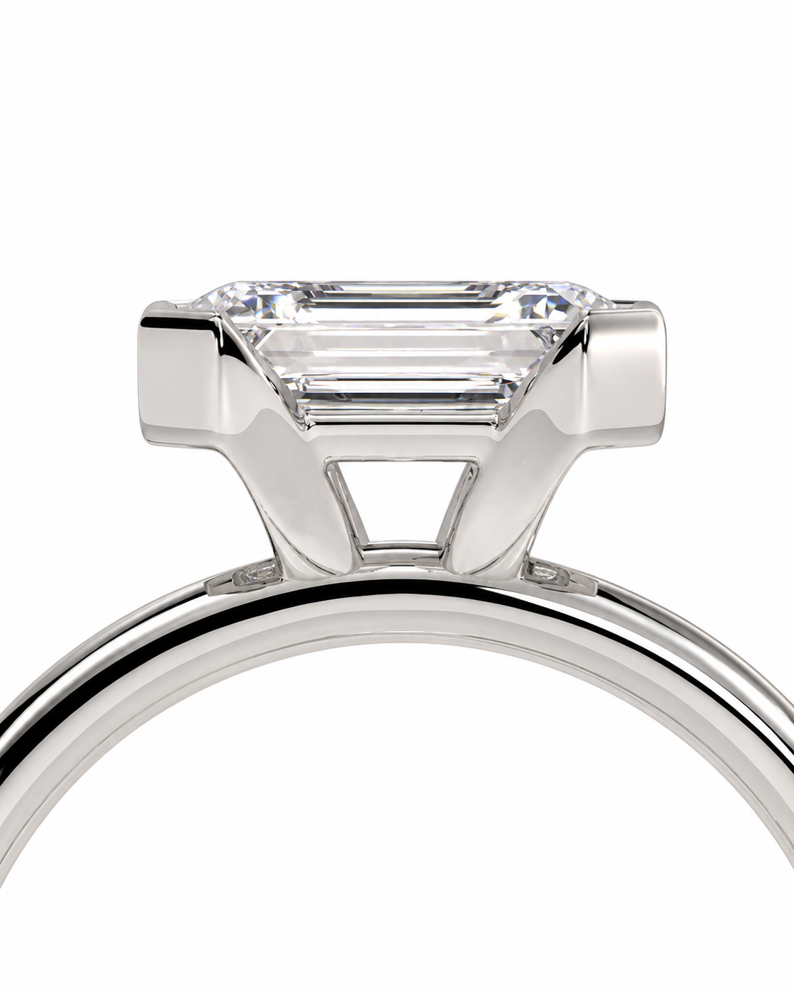 color_925_SIL,color_935_ARG,color_10K_WG, color_14K_WG &&A close-up studio shot of a silver-toned ring featuring a rectangular baguette-cut clear gemstone in a four-prong setting, shown against a plain white background.