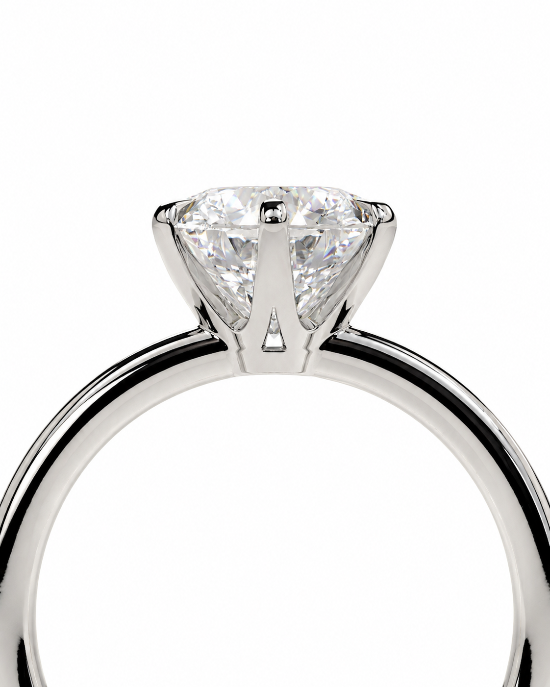 color_925_SIL,color_935_ARG,color_10K_WG, color_14K_WG &&A close-up studio shot of a solitaire engagement ring featuring a round brilliant-cut diamond set in a polished white gold or platinum band, shown against a solid white background.